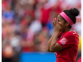 Canada's Desiree Scott wipes away tears after losing 2-1 to England during a FIFA Women's World Cup quarter-final soccer game in Vancouver, B.C., on Saturday June 27, 2015.
