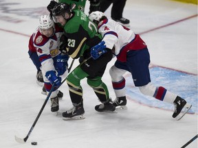 Edmonton Oil Kings Brett Kemp (24) and Will Warm (4) tie up Prince Albert Raiders Eric Pearce (23) during second period WHL playoff action on Sunday, April 28, 2019, in Edmonton .