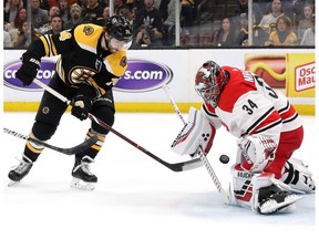 Jake DeBrusk #74 of the Boston Bruins shoots the puck against Petr Mrazek #34 of the Carolina Hurricanes during the first period in Game 2 of the Eastern Conference Final during the 2019 NHL Stanley Cup Playoffs at TD Garden on May 12, 2019 in Boston, Massachusetts.