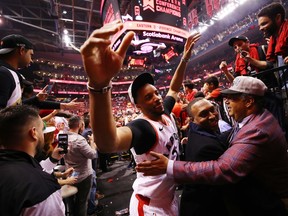 Norman Powell of the Toronto Raptors high fives fans as he walks off the court after defeating the Milwaukee Bucks 100-94 in game six of the NBA Eastern Conference Finals to advance to the 2019 NBA Finals at Scotiabank Arena on May 25, 2019 in Toronto, Canada.