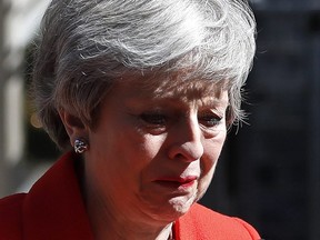 British Prime Minister Theresa May reacts as she turns away after making a speech in the street outside 10 Downing Street in London, England, Friday, May 24, 2019. Theresa May says she'll quit as UK Conservative leader on June 7, sparking contest for Britain's next prime minister. (AP Photo/Alastair Grant)