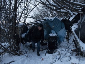 Doug Cooke, team lead with Boyle Community Services Street Outreach, checks on a homeless encampment in Edmonton's river valley, early Thursday Feb. 7, 2019.