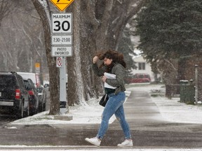 A Concordia University of Edmonton student makes their way to class during a spring snowstorm in Edmonton, on Tuesday, April 30, 2019.
