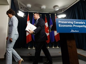 Premier Jason Kenney (right) leaves with Energy Minister Sonya Savage after speaking about Bill 12, the turn-off-the-taps legislation, during a press conference in the media room in the Alberta Legislature in Edmonton, on Wednesday, May 1, 2019.