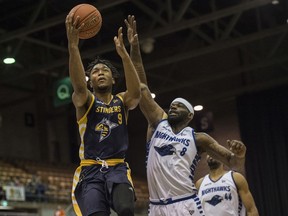 Mathieu Kamba of the Edmonton Stingers, drives to the basket but misses the layup after beating Chadrack Lufile of the Guelph Nighthawks at the Edmonton Expo Centre on May 24, 2019.