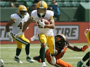 Edmonton Eskimos Jordan Robinson eludes a tackle by B.C. Lions Ebo Ogundeko during pre-season Canadian Football League game action in Edmonton on Sunday May 26, 2019.