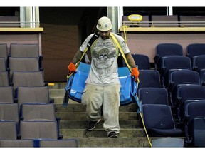 A worker (Eric Navarro) removes seats at the former Northlands Coliseum on Thursday May 30, 2019. The City of Edmonton is selling 5000 pairs of seats for $230 a pair. Seats are being sold online at www.govplanet.com/coecoliseumseats.