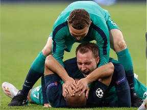 Tottenham's Brazilian forward Lucas celebrates with teammates Tottenham's Danish midfielder Christian Eriksen (C) and Tottenham's English defender Kieran Trippier (up) during the UEFA Champions League semi-final second leg football match between Ajax Amsterdam and Tottenham Hotspur at the Johan Cruyff Arena, in Amsterdam, on May 8, 2019.