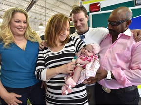 Good Samaritans Tamala Peters (left) and Bernard DePeiza (right) celebrate baby Cali Savage's healthy arrival with her mother, Crystal Black and father, Shane Servage.