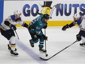 St. Louis Blues' Jay Bouwmeester,left, and Robert Bortuzzo, right, battle for the puck against San Jose Sharks' Kevin Labanc in the third period in Game 5 of the NHL hockey Stanley Cup Western Conference finals in San Jose, Calif., on Sunday, May 19, 2019.