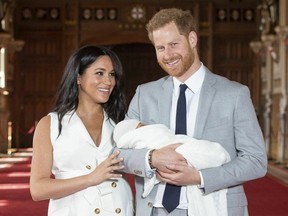 Prince Harry and Meghan, Duchess of Sussex, during a photocall with their newborn son, in St George's Hall at Windsor Castle, Windsor, south England, Wednesday May 8, 2019. (Dominic Lipinski/Pool via AP)