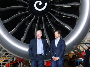 WestJet president and CEO Ed Sims, left, stands with Tawfiq Popatia, a managing director at Onex, next to one of the engines of a Boeing 787 Dreamliner aircraft in WestJet's Calgary hangers on Monday May 13, 2019. Onex announced it is buying WestJet for $5 billion.