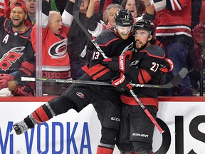 Carolina Hurricanes' Justin Faulk celebrates with teammate after scoring against the New York Islanders at PNC Arena on May 01, 2019 in Raleigh, N.C. (Grant Halverson/Getty Images)