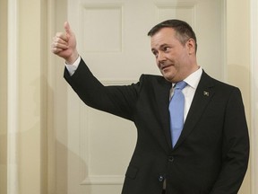 Jason Kenney gives a thumbs up as he is sworn in as premier of Alberta in Edmonton on Tuesday, April 30, 2019. Kenney will meet face-to-face today with the political foe he attacked relentlessly in his successful bid to become Alberta's premier: Prime Minister Justin Trudeau.
