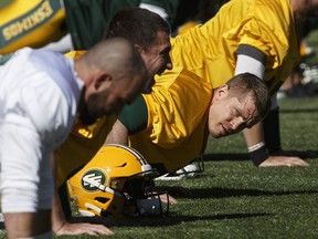 Edmonton Eskimos quarterback Trevor Harris (7) does pushups during training camp in Edmonton, Alta., on Sunday May 19, 2019.