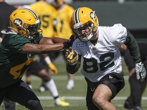 Edmonton Eskimos defensive back Jalen Spencer (47) tries to jam Greg Ellingson (82) during training camp in Edmonton on Sunday, May 19, 2019.