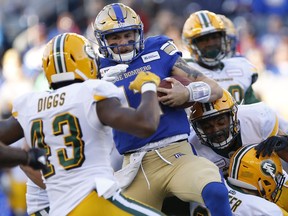 Winnipeg Blue Bombers quarterback Chris Streveler (17) gets caught by the Edmonton Eskimos as he runs for the first down during the first half of CFL action in Winnipeg Friday, May 31, 2019.