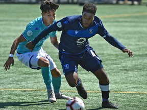 FC Edmonton Allan Zebie (4) gets away from Pacific FC Jose Hernandez (15) during Canadian Premier League action at their home opener at Clarke Stadium in Edmonton, May 12, 2019.