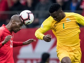 Canada's Atiba Hutchinson, left, gets his head on the ball in front of French Guiana's Soleymann Auguste during the second half of a CONCACAF Nations League qualifying soccer match in Vancouver, on Sunday March 24, 2019.