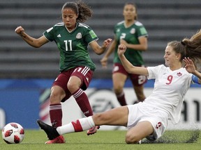 Anette Vazquez of Mexico fights for the ball with Jordyn Huitema of Canada during a 2018 FIFA U-17 Women's World Cup semifinal soccer match in Montevideo, Uruguay, Wednesday, Nov. 28, 2018.