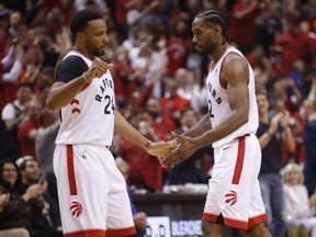 Toronto Raptors Norman Powell and Kawhi Leonard slap hands last night. JACK BOLAND/TORONTO SUN