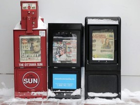 Newspaper boxes display local news in Ottawa on Jan. 3, 2018.