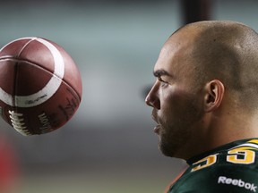 Edmonton Eskimos long snapper Ryan King flips the ball in the air on the sidelines against the Calgary Stampeders during the first half at Commonwealth Stadium in Edmonton, Alta., on Friday, Oct. 18, 2013.