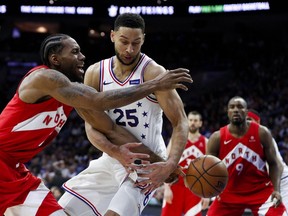 Philadelphia 76ers' Ben Simmons, centre, knocks the ball loose from Toronto Raptors' Kawhi Leonard during the second half of Game 6 of a second-round NBA basketball playoff series Thursday, May 9, 2019, in Philadelphia. (AP Photo/Chris Szagola)