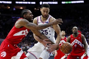 Philadelphia 76ers' Ben Simmons, centre, knocks the ball loose from Toronto Raptors' Kawhi Leonard during the second half of Game 6 of a second-round NBA basketball playoff series Thursday, May 9, 2019, in Philadelphia. (AP Photo/Chris Szagola)