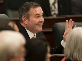 Premier Jason Kenney waves to the public gallery at the first session of the 30th Alberta Legislature with the Speech from the Throne, Wednesday, May 22, 2019.