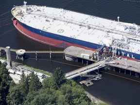 A aerial view of Kinder Morgan's Trans Mountain marine terminal filling a oil tanker in Burnaby, B.C., is shown on Tuesday, May 29, 2018. The federal Liberal government is spending $4.5 billion to buy Trans Mountain and all of Kinder Morgan Canada's core assets, Finance Minister Bill Morneau said Tuesday as he unveiled the government's long-awaited, big-budget strategy to save the plan to expand the oilsands pipeline.THE CANADIAN PRESS Jonathan Hayward ORG XMIT: JOHV107 ORG XMIT: POS1805291707390996