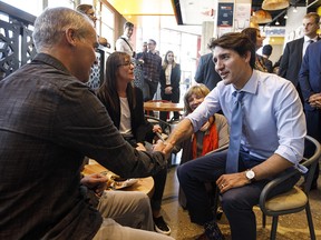 Prime Minister Justin Trudeau meets with people in a cafe during a visit to Edmonton on Friday, May 10, 2019.