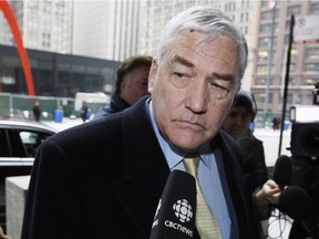FILE - In this Jan. 13, 2011 file photo, Conrad Black arrives at the federal building in Chicago. President Donald Trump has granted a full pardon to Black, a former newspaper publisher who has written a flattering political biography of Trump. Black's media empire once included the Chicago Sun-Times and The Daily Telegraph of London.