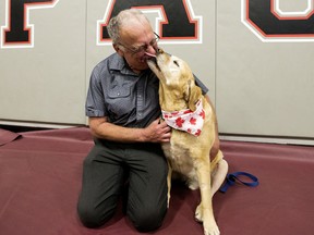 Charles Gachnang and his service dog Eddy pose for a photo, in Edmonton Monday June 17, 2019. The long-serving teacher and his Labrador retriever service dog received a surprise send-off as they prepare to retire from from Edmonton Public Schools. Charles Gachnang, a teacher with the District since 1997, is retiring from his role with the individual support program at J. Percy Page School. Service dog Eddy started working alongside Charles 10 years ago, first at Rosslyn School before moving to J. Percy Page in 2014.¤Photo by David Bloom