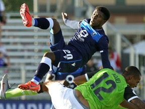 FC Edmonton's Bruno Zebi (top) collides with York9 FC's Simon Karlsson Adjei (bottom) during Canadian Premier League soccer game action in Edmonton on Wednesday June 12, 2019.