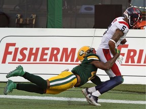 Montreal Alouettes DeVier Posey (right) runs in for the touchdown with Edmonton Eskimos Monshadrik Hunter hanging on during CFL game action in Edmonton on Friday June 14, 2019.