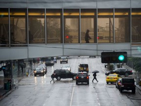 Dark and damp weather descended on the core of the city and umbrellas were common on the streets of downtown Edmonton on June 19, 2019.