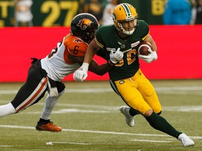 Edmonton Eskimos' Greg Ellingson (82) makes a catch as BC Lions' T.J. Lee (6) makes chase during a CFL football game at Commonwealth Stadium in Edmonton, on Friday, June 21, 2019.
