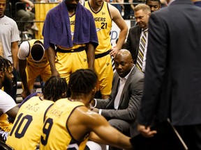 Edmonton Stingers' head coach and general manager Jermaine Small (centre) speaks with his players as they play the Niagara River Lions during CEBL action at Edmonton Expo Centre in Edmonton, on Friday, June 28, 2019.
