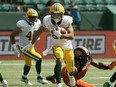 Eskimos' Jordan Robinson eludes a tackle by Lions' Ebo Ogundeko during pre-season CFL action in Edmonton on May 26, 2019.