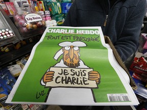 Peter Song , who runs International News on Front St. in Toronto, finally received 10 copies of of the Charlie Hebdo edition on Monday January 19, 2015. (Jack Boland/Toronto Sun/QMI Agency)