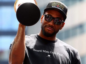 Kawhi Leonard holds the MVP trophy during the Raptors' victory parade in Toronto on June 17, 2019.