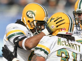 Edmonton Eskimos fullback Calvin McCarty is congratulated by teammate Fred Stamps (left) after scoring a touchdown against the Toronto Argonauts during the first-ever CFL regular season game in Atlantic Canada, Sept. 26, 2010, at Stade Moncton.