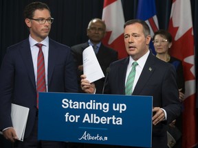 Premier Jason Kenney and Minister of Justice and Solicitor General Doug Schweitzer (left) discuss Bill 13: the Alberta Senate Election Act, at the Alberta Legislature in Edmonton Wednesday June 26, 2019. Photo by David Bloom