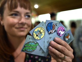 Jacinda Cote holds up some of her pins at the Share the Flair Show in Edmonton on Saturday, June 15, 2019.