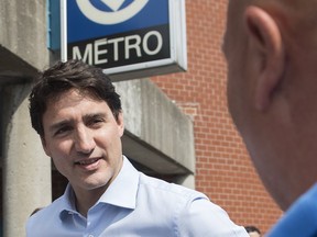 Prime Minister Justin Trudeau greets commuters outside St. Michel metro station in Montreal on July 4, 2019. (The Canadian Press)