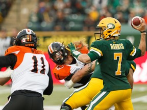 Edmonton Eskimos quarterback Trevor Harris (7) throws in the pocket as B.C. Lions defensive end Odell Willis (11) races in at Commonwealth Stadium in Edmonton on Friday, June 21, 2019.