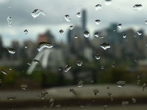 Rain drops on a window with city skyline in back, as the off and on again showers continue in Edmonton, June 24, 2019.
