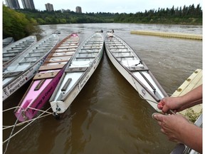 The Dragonboat Racing Club are better securing their dock along the North Saskatchewan River where water levels have been rising next to Dawson Park in Edmonton, July 9, 2019. Ed Kaiser/Postmedia