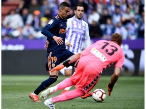 Valencia's forward Rodrigo Moreno scores a goal against Real Valladolid's goalkeeper Yoel Rodriguez during the Spanish League football match between Real Valladolid and Valencia at the Jose Zorrilla stadium in Valladolid, Spain on May 18, 2019.